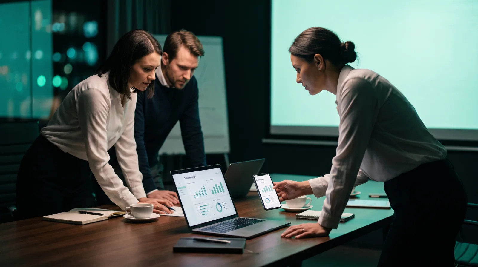 A small business team reviewing a Cliqer presentation plan together at a bright meeting table